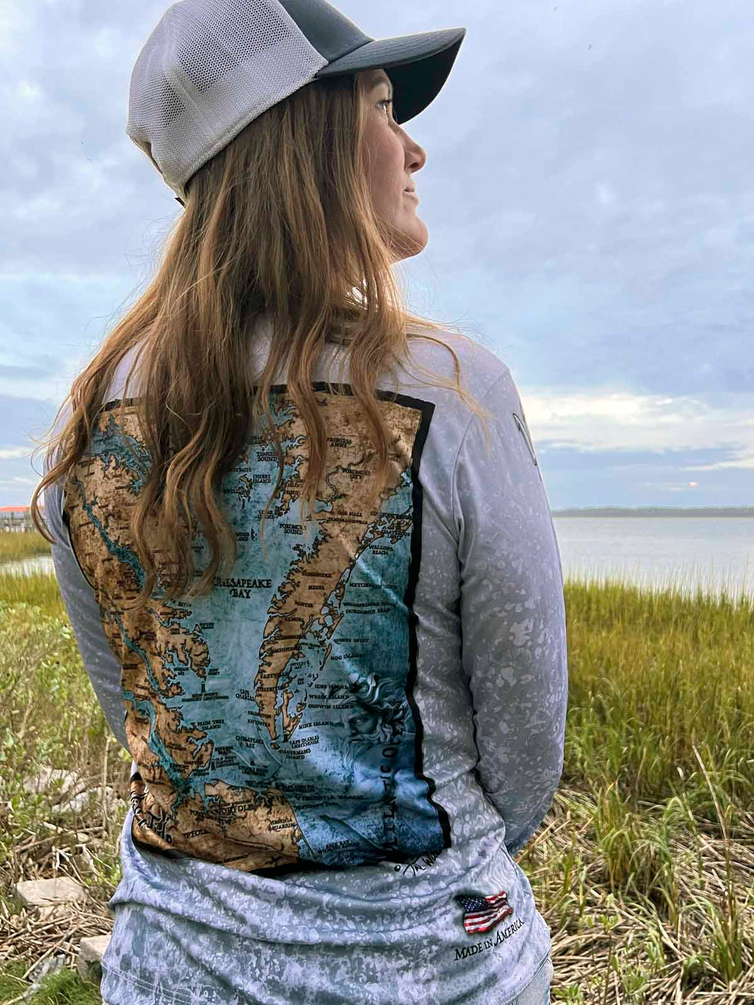 beautifully detailed fine art map of Chesapeake Bay, VA rests on a sophisticated slate fossil background. Vintage style coloring and stunning artwork on a long sleeve King Tide ladies V Neck performance shirt.
