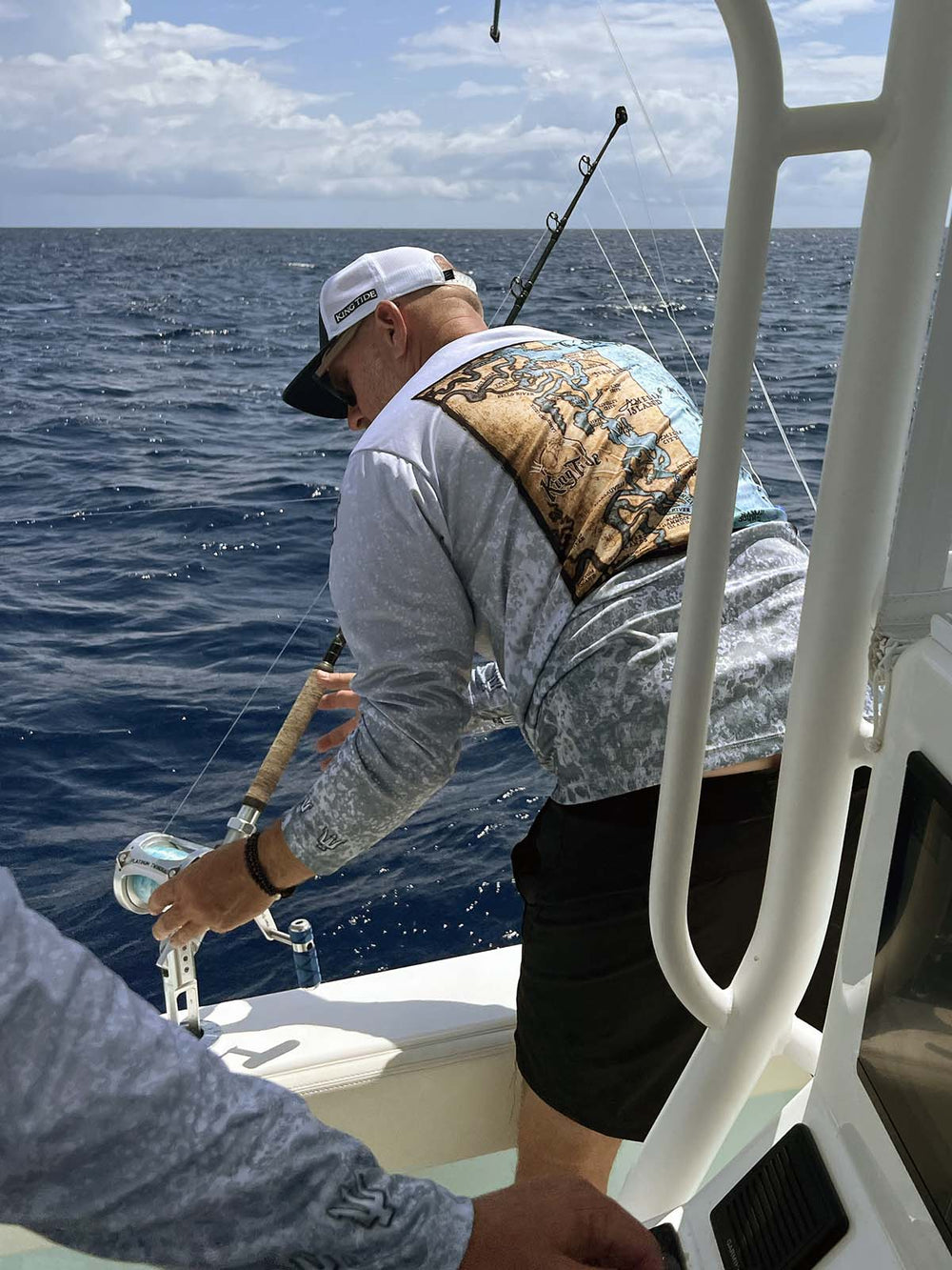 Amelia Island / Fernandina map on the back of a long sleeved King Tide shirt with a textured slate fossil allover print.  UPF50 XS-5X Made in USA. Original art and design by Tal Willis
