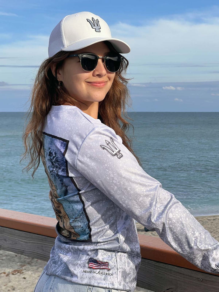 Long sleeve performance shirt with slate fossil, allover print.  Right side showing trident on sleeve at shoulder. UPF 50. XS-2X. American flag 'Made in America' at bottom.  Original art and design by Tal Willis.