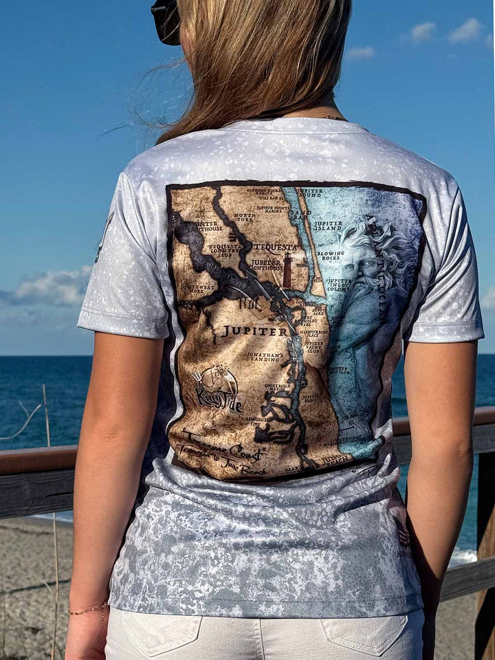 Vintage style map of Jupiter, FL  on back of short sleeve ladies V Neck performance shirt with slate fossil allover print. UPF 50. XS-4X. Made in USA. Original art and design by Tal Willis.
