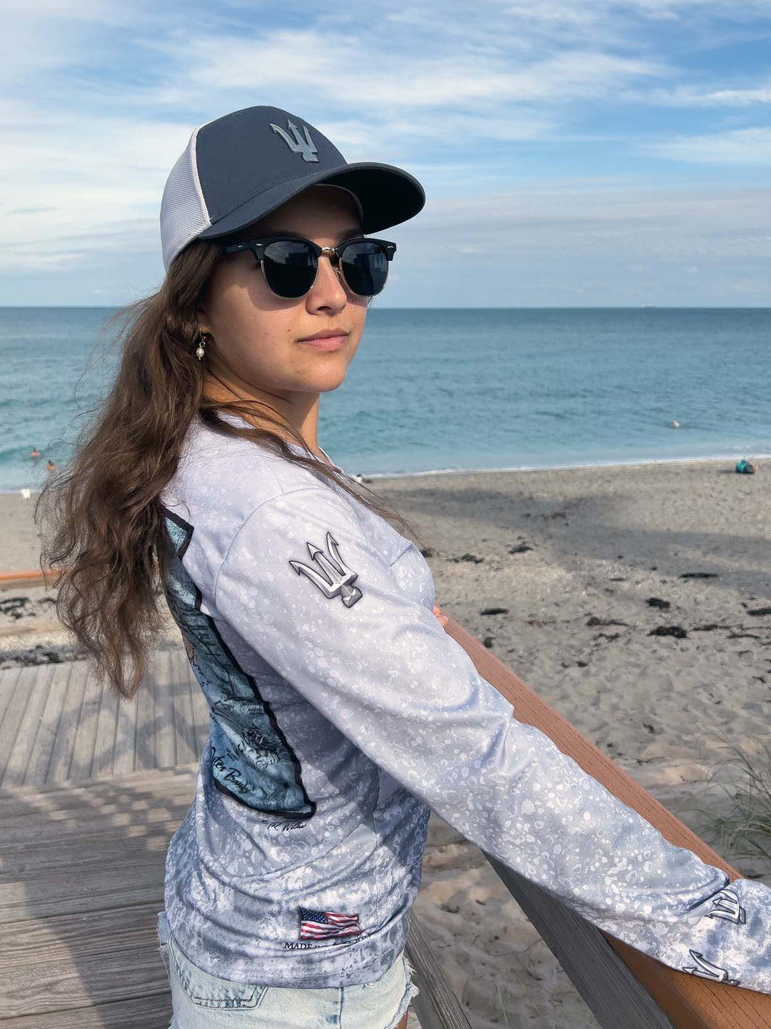 Long sleeve performance shirt with slate fossil, allover print.  Right side showing tridents on sleeves at shoulders and wrists. UPF 50. XS-2X. Made in USA. Original art and design by Tal Willis.