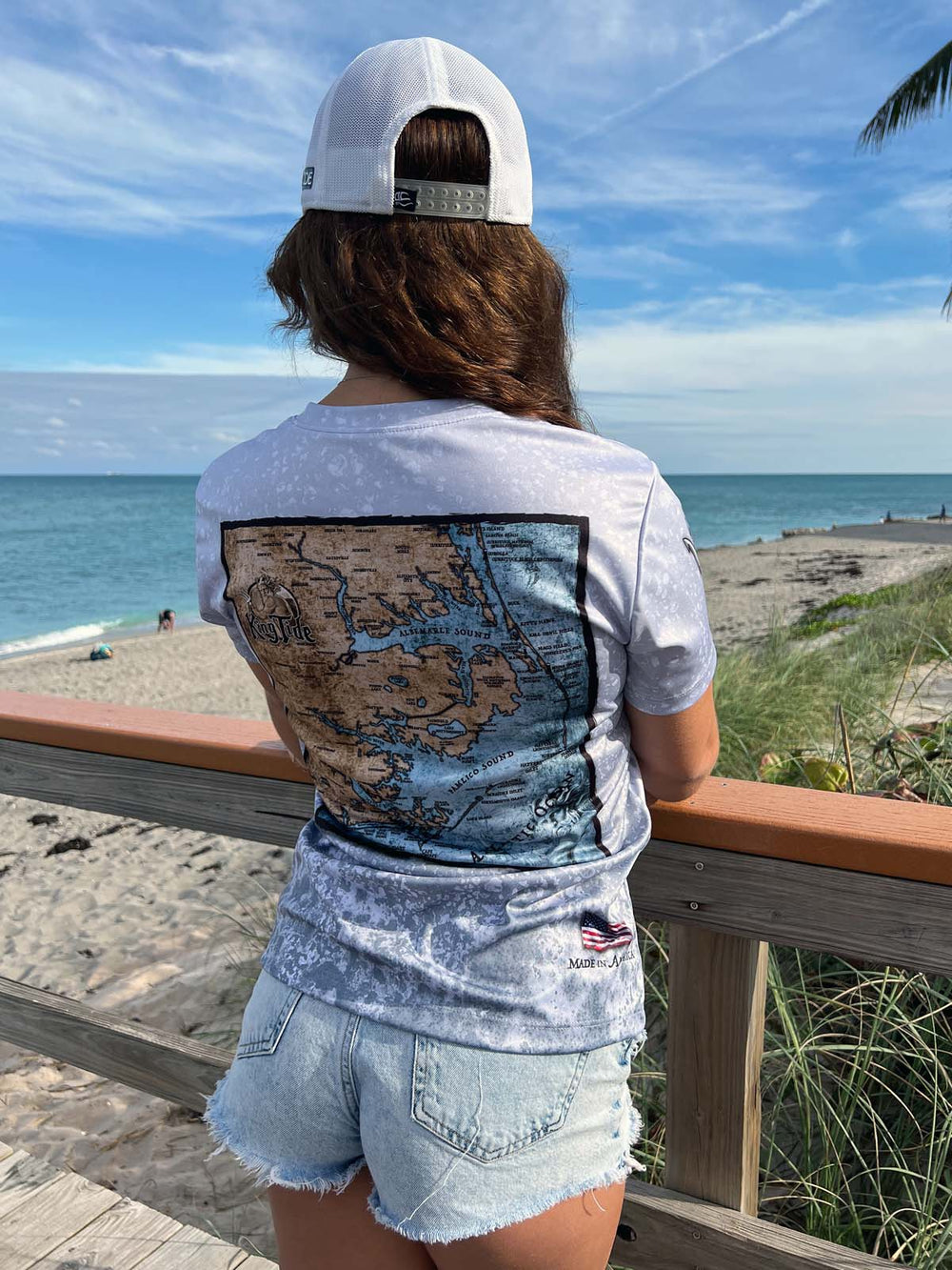 Short Sleeve V neck performance shirt with slate fossil allover print. Back features vintage style map of the Outer Banks. UPF 50. XS-4X. Made in USA. Original art and design by Tal Willis.