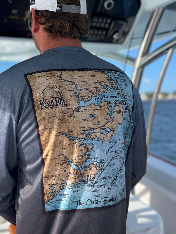 King Tide long sleeve performance shirt in serene black.  Back side features vintage style map of The Outer Banks. UPF 50 XS-5X. Made in USA. Original artwork and design by Tal Willis.
