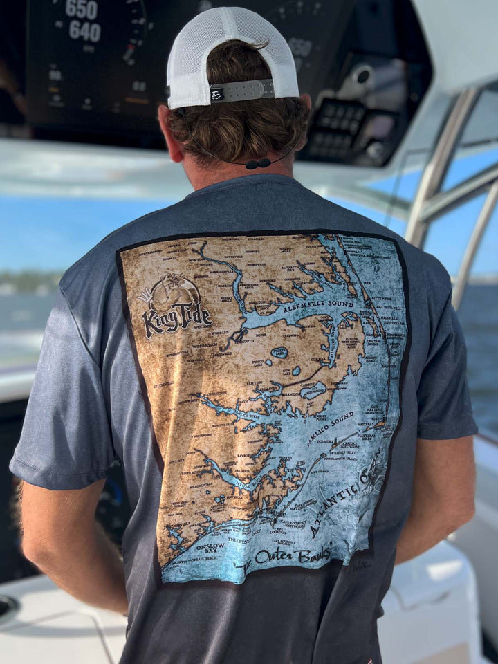 Short sleeve, serene black allover print performance shirt. Back shows vintage style map of the Outer Banks. UPF 50. XS-5X. Made in USA. Original art and design by Tal Willis. 