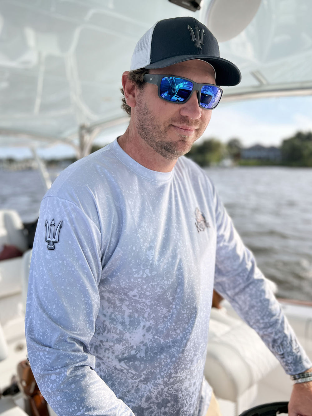 Long sleeve performance shirt with slate fossil, allover print.  Front side showing King Tide logo on left chest, tridents on sleeve at shoulder. UPF 50. XS-5X. Made in USA. Original art and design by Tal Willis.
