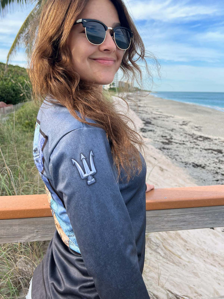 Ladies long sleeve, serene black V Neck. Right side showing tridents on sleeve at shoulder. UPF 50. XS-2X. Made in USA. Original art and design by Tal Willis.