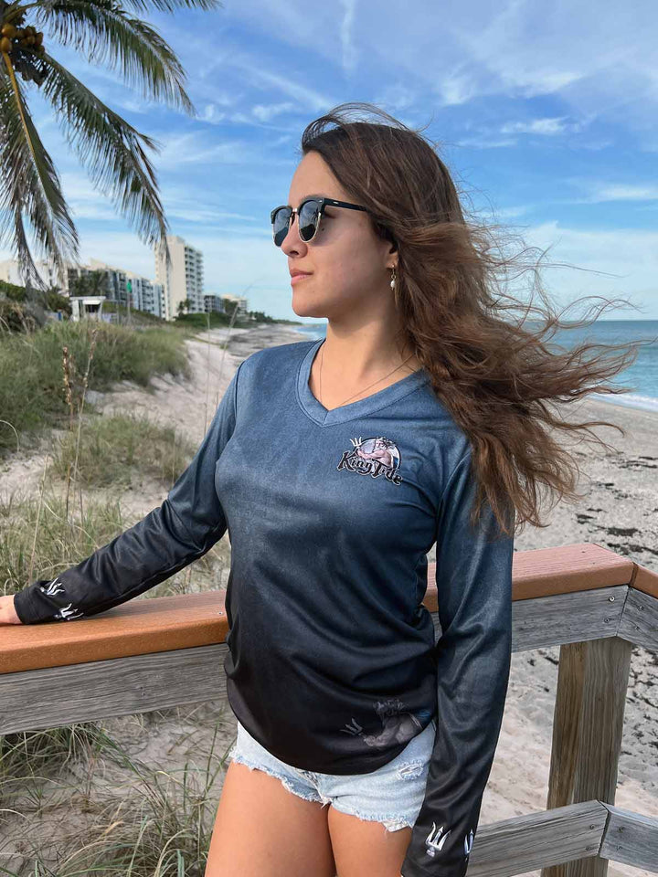 Long Sleeve performance shirt in Serene Black. King Tide logo on left chest. Tridents on sleeve wrists.