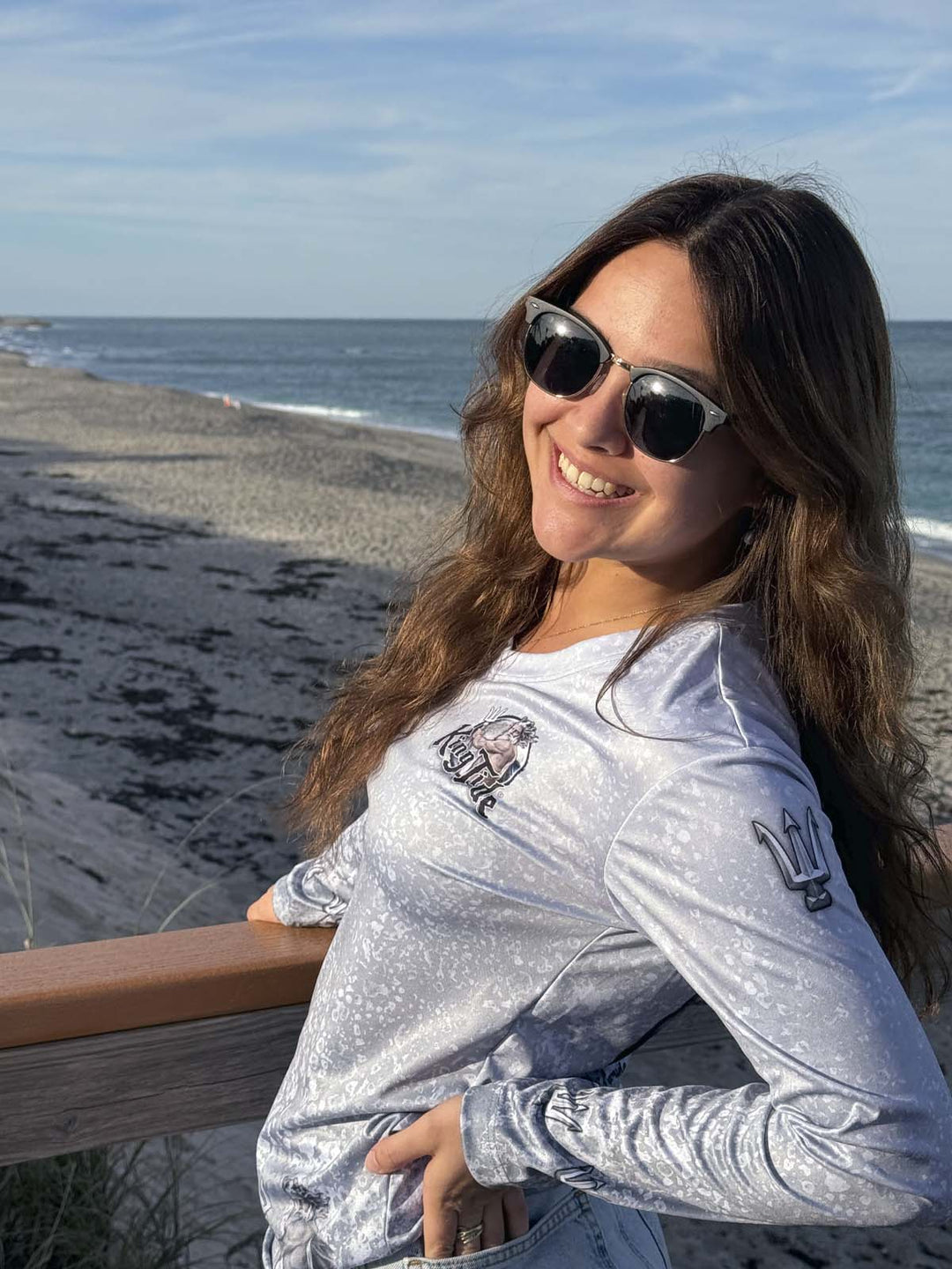 Long Sleeve, V neck performance shirt with slate fossil allover print. Front side with King Tide logo on left chest. Trident on sleeves at shoulder and wrist.