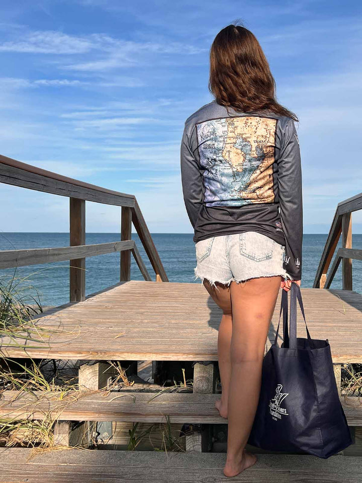King Tide long sleeve performance shirt in serene black.  Back side features vintage style map of coastal Tampa. UPF50 XS-2X Made in USA. Original artwork and design by Tal Willis.