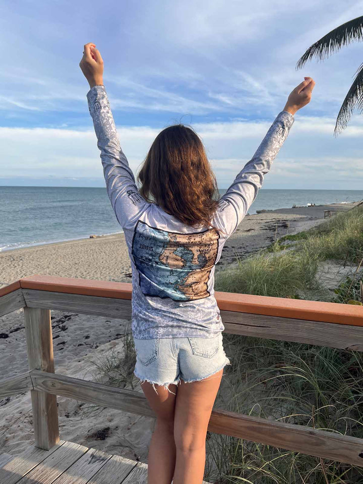 Vintage style Tampa, FL coastal map on back side of long sleeve performance shirt with an allover slate fossil print. UPF50. XS-2X. Made in USA